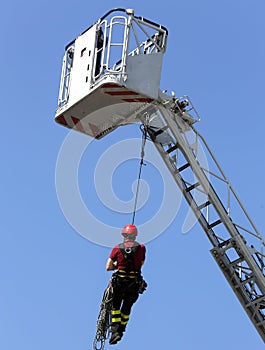 Firefighter hung the rope climbing during the practical exercise