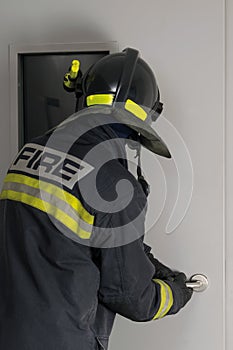 Firefighter looking through a closed door window