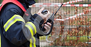 Firefighter operate with a walkie talkie in action - Serie Firefighter photo