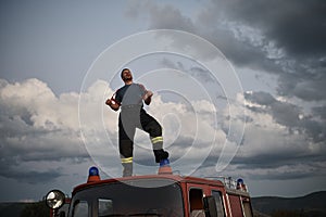 Firefighter out of duty on top of truck