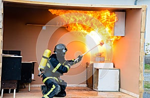 Firefighter pouring water on an oil fire - explosion