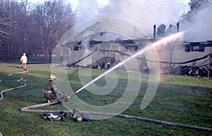 Firefighter pour water on a building on fire