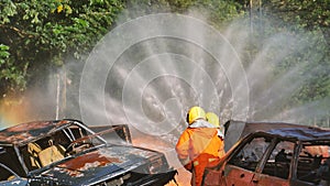 Firefighter Rescue team training in fire fighting extinguisher. Firefighter teamwork fighting with flame using fire hose chemical