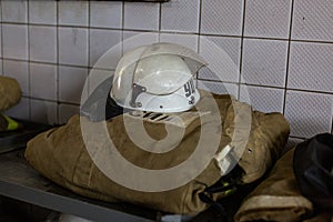Firefighter`s clothes are folded on a table