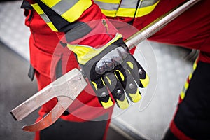 Firefighter's Protective Gloves Holding Special Iron Tool