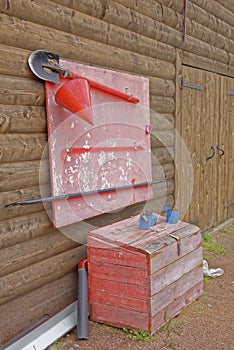 Firefighter shield with buckets, shovels, fire extinguisher