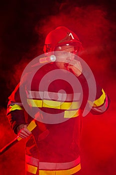 Firefighter shouting in red smoke.