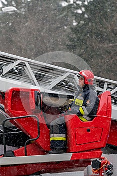 Firefighters operating crane arm