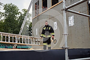 Firefighter stand next to dummy building