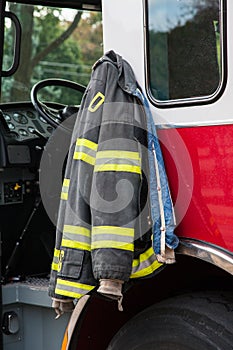 Firefighter suit Hanging on the Door of Fire Truck