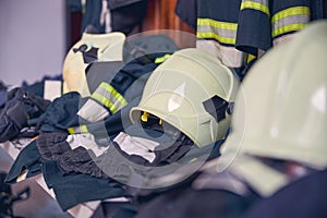 Firefighter suits and helmets hanging at fire station