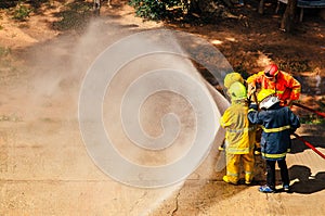 Firefighter training., fireman using water and extinguisher to fighting with fire flame in an emergency situation.