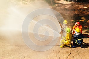 Firefighter training., fireman using water and extinguisher to fighting with fire flame in an emergency situation.