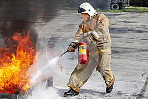 Firefighter during training with a huge fire in the brazier