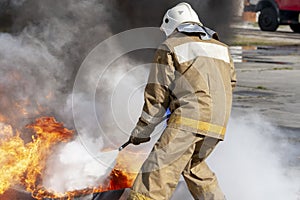 Firefighter during training with a huge fire in the brazier