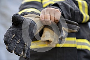 Firefighter wearing glove at fire station ready to rescue