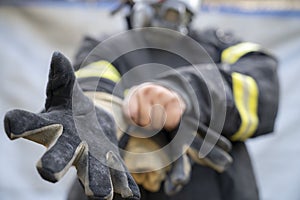 Firefighter wearing glove and safety suite ready to rescue