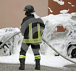 Firefighter wearing protective helmet uniforms holding a hose an