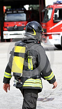 Firefighter with yellow oxygen cylinder and the helmet