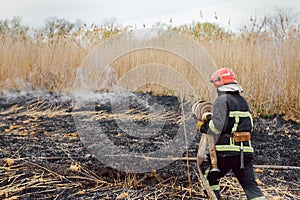 Firefighters battle a wildfire. firefighters spray water to wildfire. Australia bushfires, The fire is fueled by wind and heat