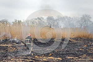 Firefighters battle a wildfire. firefighters spray water to wildfire. Australia bushfires, The fire is fueled by wind and heat