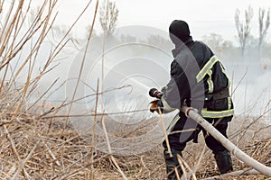 Firefighters battle a wildfire. firefighters spray water to wildfire. Australia bushfires, The fire is fueled by wind and heat