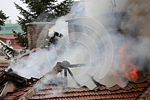 Firefighters burning house