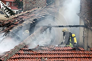 Firefighters burning house