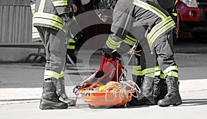 Firefighters carry the injured person on a stretcher after the accident