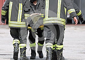 Firefighters carrying an injured man on a stretcher