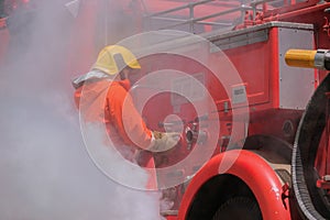 Firefighters drag fire hoses connected to fire truck hoses. emergency situations caused by fire