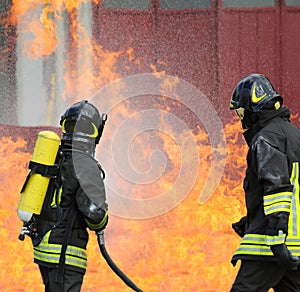 Firefighters during exercise to extinguish a fire in a car