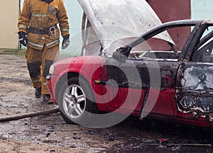 Firefighters extinguish a burning car with water, fire, extinguish