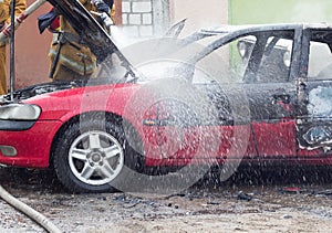 Firefighters extinguish a burning car with water, fire, extinguish