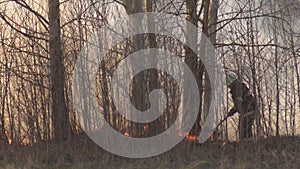 Firefighters extinguish dry grass and burning forest during a fire, spring, fire danger, background