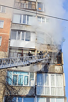 Firefighters extinguish a fire while climbing the stairs, risking their lives in danger in a multi-story building