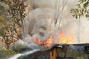 Firefighters extinguish a fire in a garage