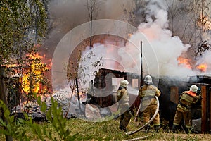 Firefighters extinguish a fire in a garage