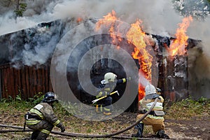 Firefighters extinguish a fire in a garage