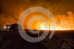 Firefighters extinguish a forest fire. Forest fire at night.