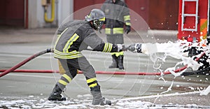 Firefighters while extinguishing the fire with foam