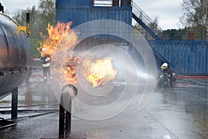 Firefighters extinguishing pipeline fire photo