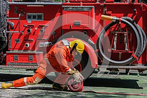 Firefighters and Fire hose coil fire and rescue training school regularly to get ready - help, fire protection concept