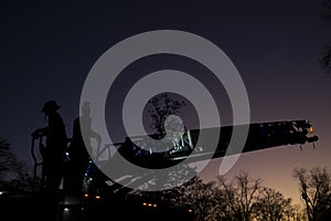 Firefighters on Ladder Truck at Sunset