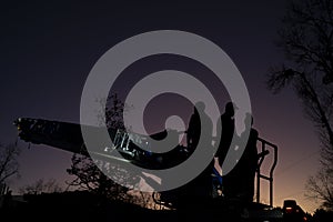 Firefighters on Ladder Truck at Sunset