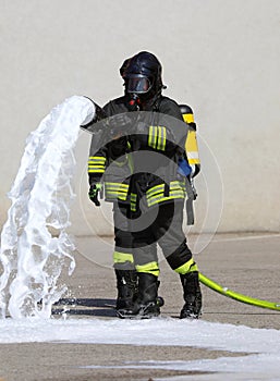 firefighters with oxygen tanks during emergency powerful fire hose with foam