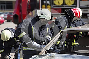 Firefighters with the pneumatic shears open the car doors