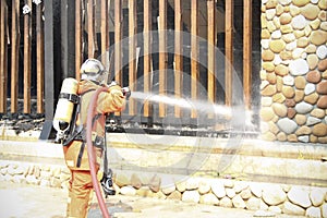 Firefighters prepare to attack a propane fire during a training exercise