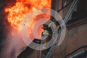 Firefighters put out large massive fire blaze, group of fire men in uniform during fire fighting operation in the city streets,