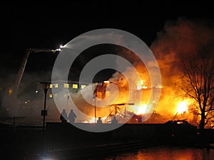 Firefighters putting out burning house.